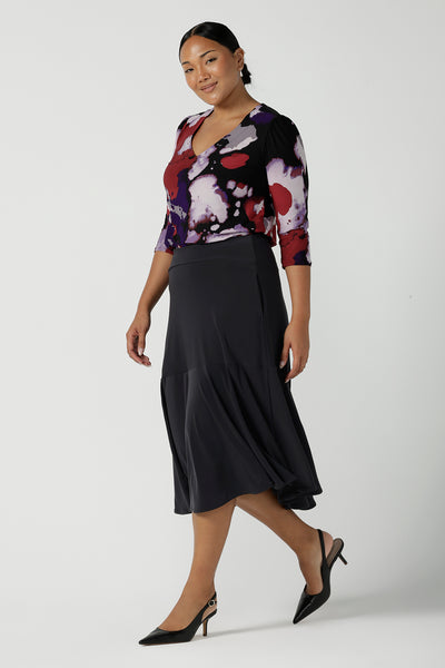 Size 10 woman wears the Vida top in Fitzroy with a V-neckline and 3/4 sleeve. Curved hemline and comfortable workwear for women made in Australia for women size 8 to 24.