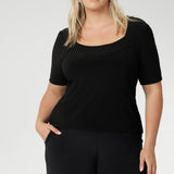 Elevate your wardrobe with this short sleeve black jersey top, designed for women over 30 who value both style and versatility. Featuring a flattering square neckline and a slim, tailored fit, this classic black top transitions effortlessly from office to off-duty. Perfectly paired with workwear separates for a polished professional look or styled with denim for elevated smart-casual dressing. Shop this essential women’s top online at Australian fashion label Leina + Fleur, available in inclusive sizes 8–24