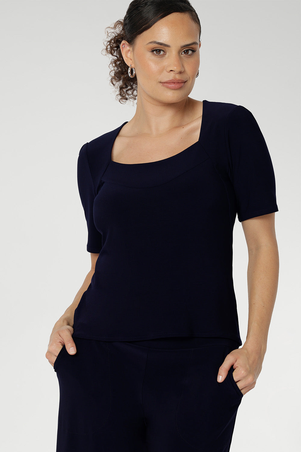Australian made women's top has short fitted sleeves, a square neckline and and high-low. Ideal piece for weekend casual and travel capsule wardrobes. Available in sizes 8-24.