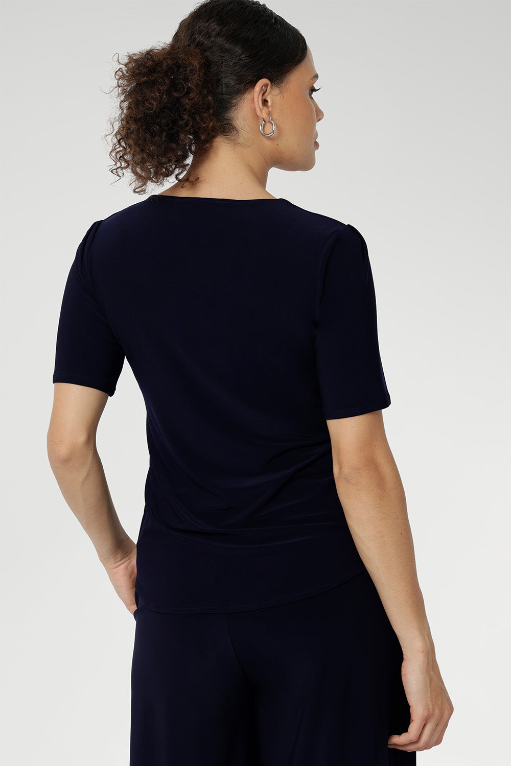 Australian-made women's top. Features short fitted sleeves and a square neckline. Stretchy fabric is perfect for weekend casual and everyday work wear. Available in sizes 8-24. Women's Navy Jersey Top.