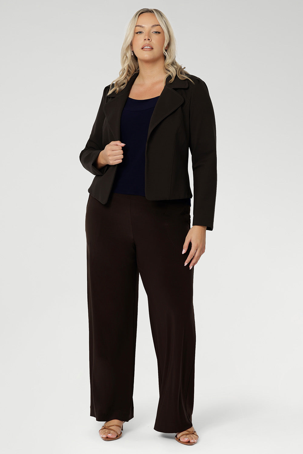 Short fitted sleeved women's Top made from stretchy fabric is perfect for weekend casual and everyday work wear. Available in sizes 8-24. Women's Navy Jersey Top is worn with Brown Pants and Brown Structured Jacket.
