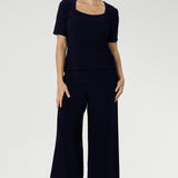 Navy short sleeved women's Top made from stretchy fabric is Australia. Available in sizes 8-24. Women's Navy Jersey Top is worn with navy culotte.