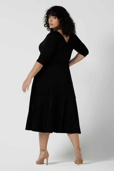 Reverse side of the Bettina dress in black, a size 16 Woman wears a Bettina Petite Reversible dress in black. A reversible dress for stylish casual wear. Soft stretch jersey with pockets and a wrap top. Made in Australia for women. Size 8 - 24.