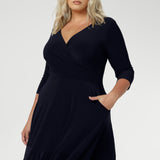 Close up of a size 18 woman wears a Bettina Reversible dress in Navy. Stylish workwear for women. Midi length with functional pockets. Made in Australia for women size 8 - 24. Soft Navy jersey fabric.