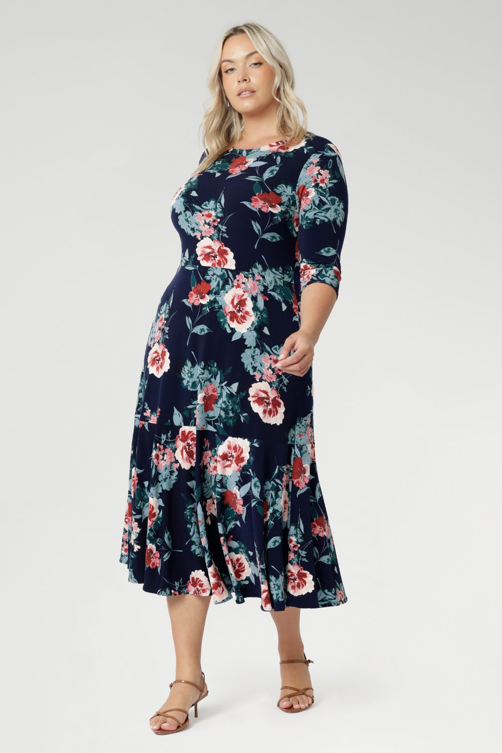 Crafted from a soft-stretch, dry-touch jersey fabric, the Vintage Rose print features delicate floral detailing in shades of pink, red, and blue on a timeless navy background. The 3/4 length sleeves offer coverage with a touch of sophistication, while the flowing maxi skirt is finished with a ruffle hemline for added movement and flair.