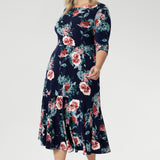 Crafted from a soft-stretch, dry-touch jersey fabric, the Vintage Rose print features delicate floral detailing in shades of pink, red, and blue on a timeless navy background. The 3/4 length sleeves offer coverage with a touch of sophistication, while the flowing maxi skirt is finished with a ruffle hemline for added movement and flair.