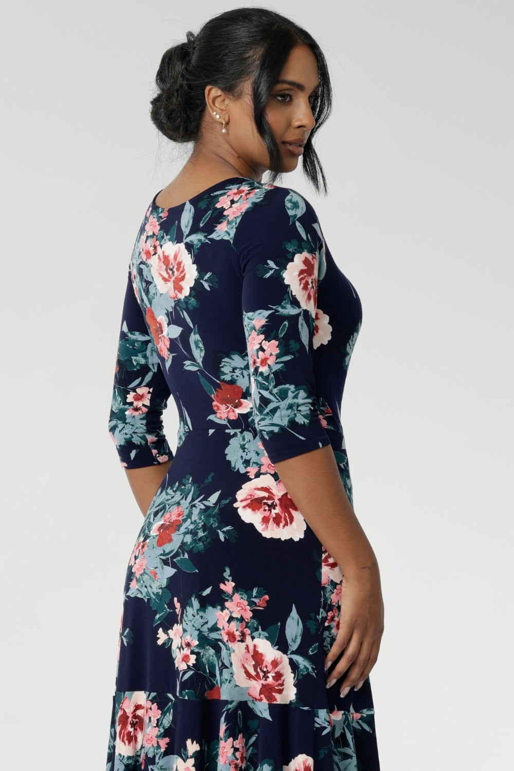 Whether you're heading to a special event or dressing up for everyday elegance, this reversible maxi dress is a wardrobe essential. Crafted from a soft-stretch, dry-touch jersey fabric, the Vintage Rose print features delicate floral detailing in shades of pink, red, and blue on a timeless navy background. The 3/4 length sleeves offer coverage with a touch of sophistication, while the flowing maxi skirt is finished with a ruffle hemline for added movement and flair.