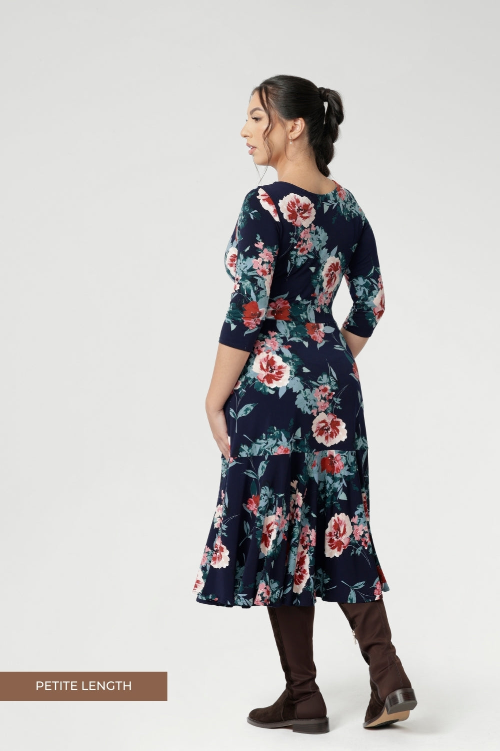 This flattering silhouette can be worn with the V-neck wrap front for a more defined, feminine shape, or reversed to feature a classic boat neckline that pairs beautifully with structured jackets or cardigans. Available in sizes 8-24 in both petite & regular sizes.