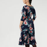This flattering silhouette can be worn with the V-neck wrap front for a more defined, feminine shape, or reversed to feature a classic boat neckline that pairs beautifully with structured jackets or cardigans. Available in sizes 8-24 in both petite & regular sizes.