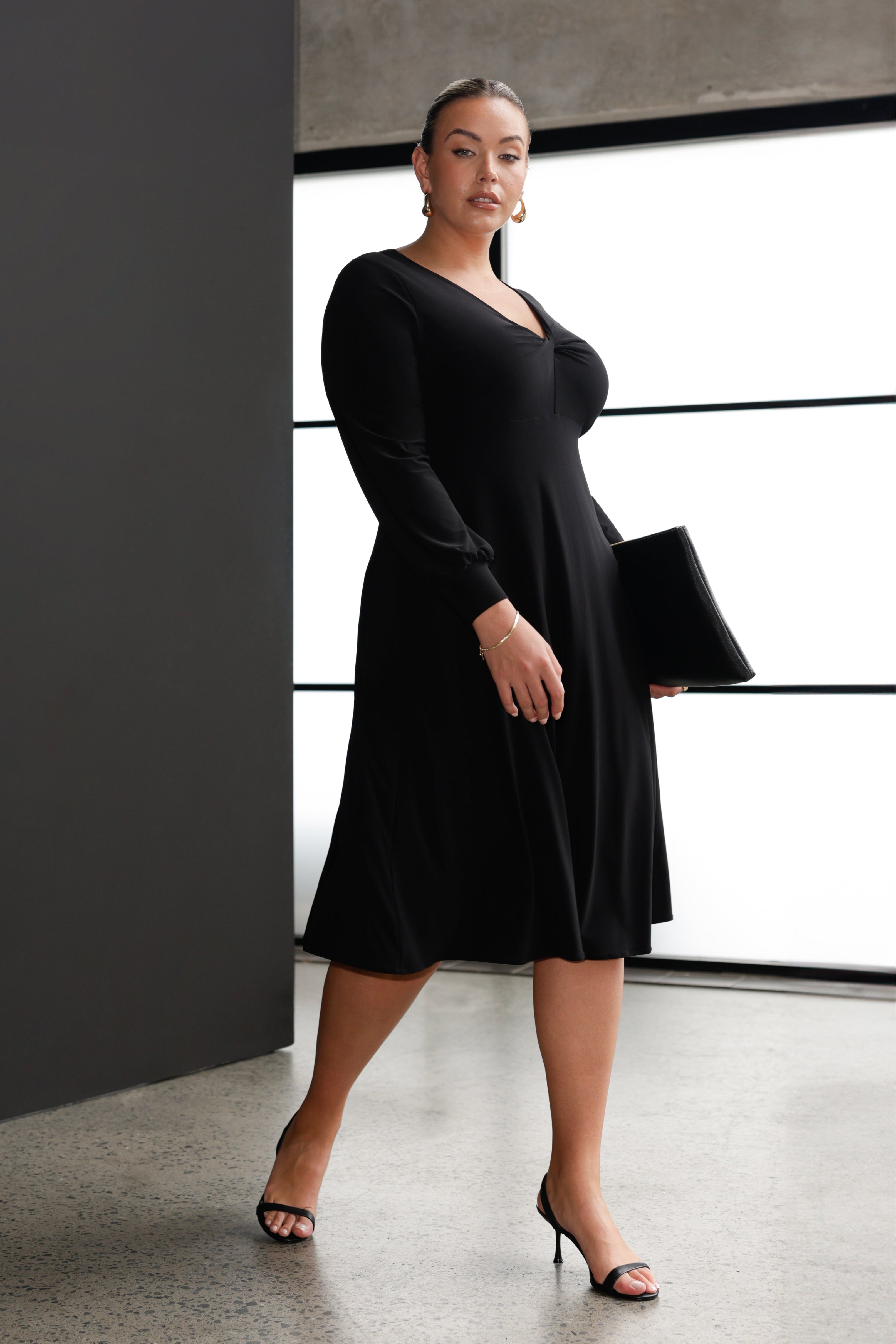 Perfect for layering under a jacket or coat, the Bianca Dress transitions seamlessly into the cooler months with stockings and boots, making it a go-to for stylish winter dressing or for on the go Workwear elegance.