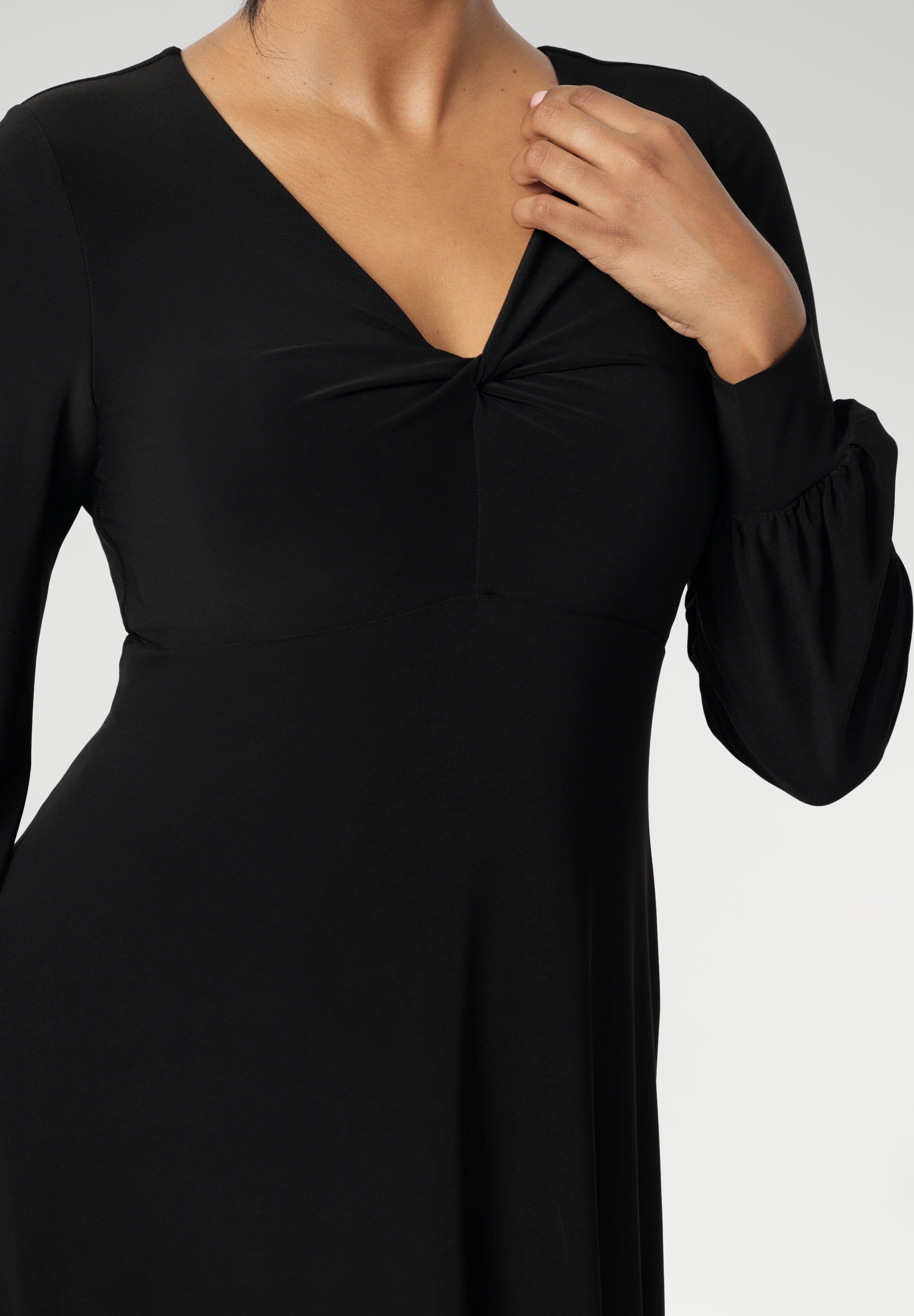 The Bianca Dress is a timeless black knee-length style designed for both work and special occasions. Featuring a sophisticated V-neckline with a twist-front bodice and cuffed long sleeves, it creates a flattering silhouette with elegant detail. Made in Australia from our signature dry-touch jersey fabric.