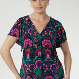 The Bowie Top is a must-have addition to your spring wardrobe, crafted from our signature dry-touch stretch jersey that offers a soft, breathable feel with all-day comfort. Showcasing a vibrant floral print in bold shades of pink, green, burgundy, and blue, this top blends effortless style with easy wearability.