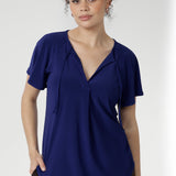 Crafted from a dry-touch jersey with gentle stretch, the Bowie Top in Sapphire offers a relaxed silhouette complemented by a V-neckline, soft pleat detailing, and tie accents. Finished with flutter sleeves and a shirttail hem, it transitions effortlessly from weekday to weekend wear.