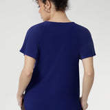 Tailored from smooth dry-touch jersey with comfortable stretch, the Bowie Top in Sapphire combines a relaxed fit with thoughtful detailing, a V-neckline, front pleats, and tie accents. Flutter sleeves and a softly curved shirttail hem complete this versatile, feel-good essential.