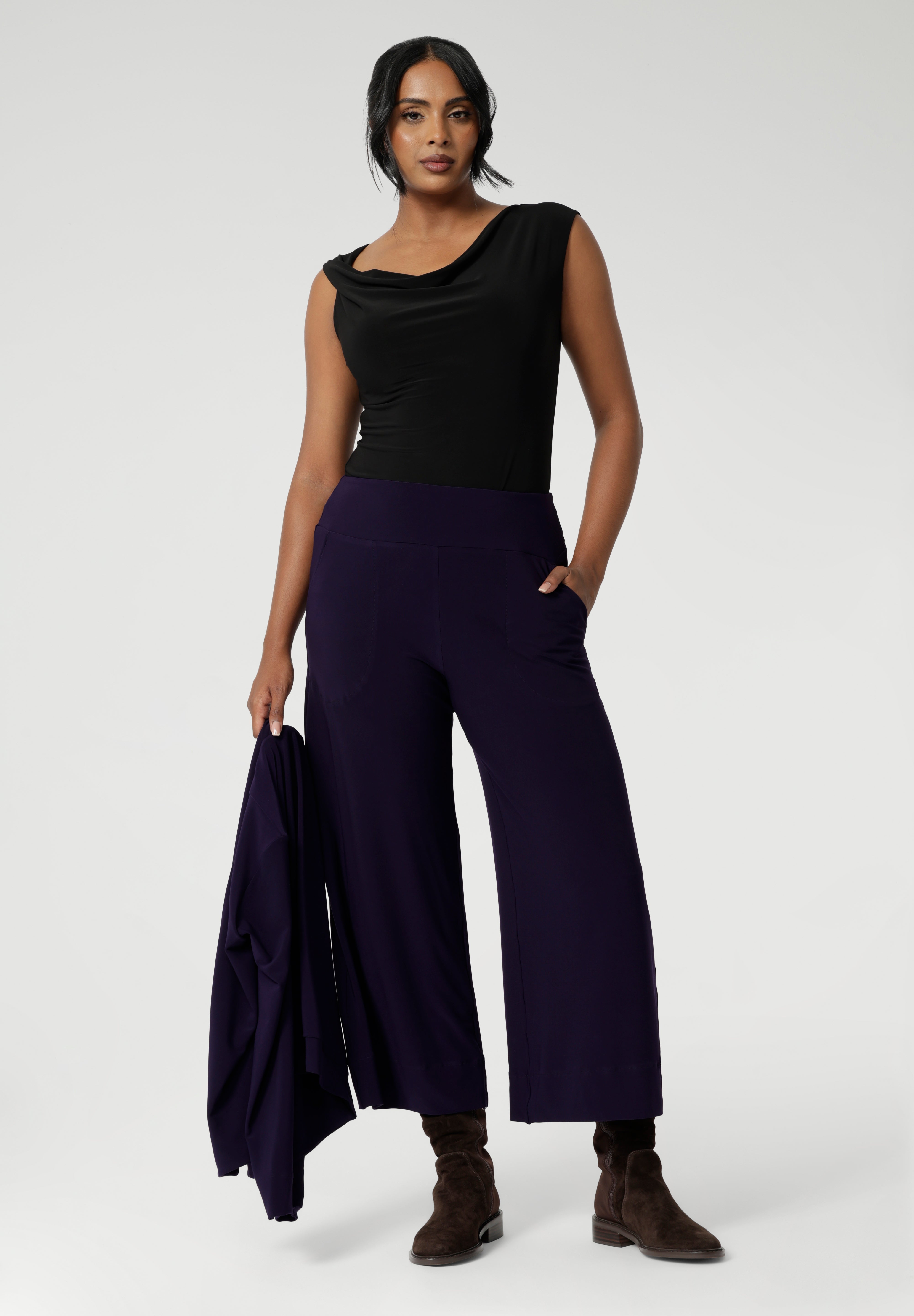 Available in sizes 8-24 and in both regular and short lengths, the Bradley Culotte caters to a variety of body types, ensuring the perfect fit for every woman. Pair them back with the Sandro Jacardi for a soft suiting combination that is both comfortable and chic. Over 30's woman wears culottes with black cowl neck top and matching cardigan.