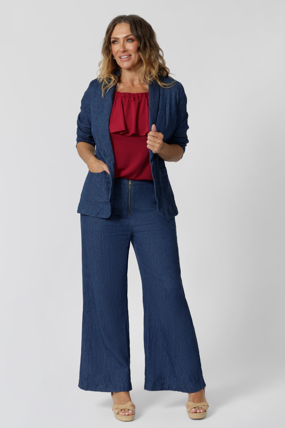 40-year-old woman wears red frill top, styled with Vintage Denim range from Leina & Fleur. Made to drape beautifully and go with everything. The red colour fabric is made of slinky jersey. Australian made quality and easy to care piece allows expression of your unique style. Fashion brand Leina and Fleur proudly stock plus and petite sizes from 8 to 24. Happy Shopping!