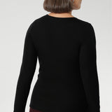 Stay effortlessly stylish through the cooler months with this luxuriously soft knit top, crafted from a premium Tencel wool blend. Designed for comfort and versatility, it features a flattering close-to-body fit that moves with you, thanks to its generous stretch and breathable finish. Black knit top has thumbholes that can be used or tucked away for versatility in styling and extra warmth.