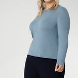Crafted from a luxe blend of Tencel wool, this soft knit top is your go-to light layer for the cooler months. Featuring a classic round neckline and long sleeves, it’s designed with comfort in mind — offering generous stretch and a smooth, breathable feel, without the itch of traditional merino. Worn solo or layered under a jacket or coat, it pairs effortlessly with your favourite pants or skirts for an elegant, everyday look.