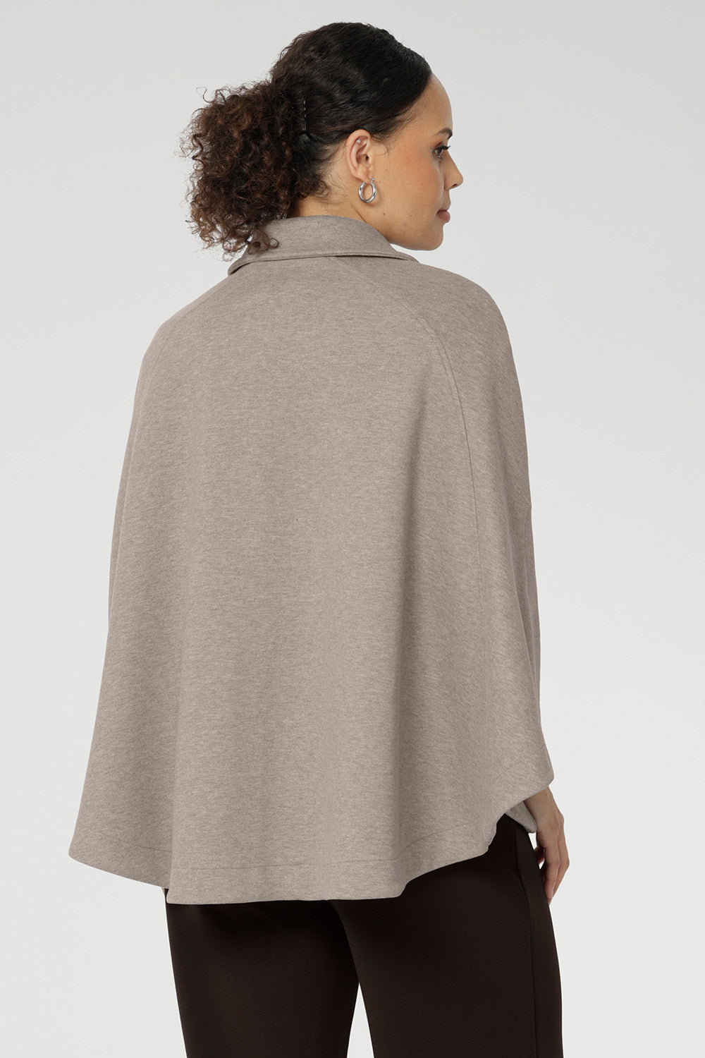 Unlike traditional belted coats, the back of this cape remains free from the tie, allowing the fabric to drape beautifully for full range of motion and an elegant finish.