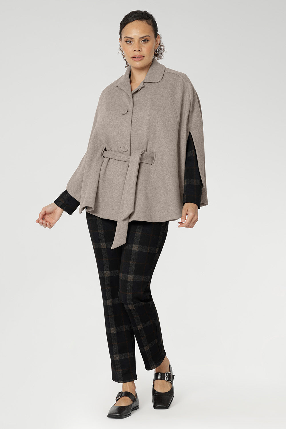 Ideal for layering, it delivers a spacious yet flattering fit designed to move with you through winter in effortless style.The tailored silhouette is enhanced with three front buttons that fasten cleanly across the chest, while a cleverly designed waistband wraps around the back and threads through discreet loop holes to cinch the waist.