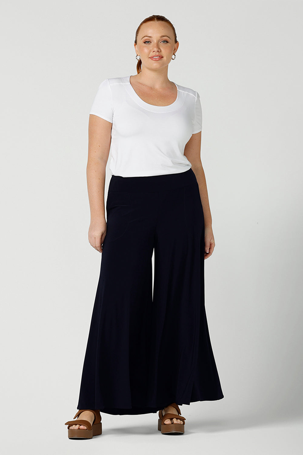 A good example of ladies clothing in Australia, this round neck, short sleeve top in white bamboo jersey is shown in a size 12 on a curvy woman. Worn with navy, wide leg palazzo pants, if you're seeking a ladies casual top then this white tee top by Australian women's online clothing brand, Leina & Fleur,  is the perfect edition to your capsule wardrobe!