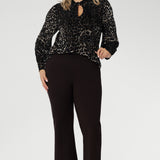 The Celine Top in Animal Burnout is a sophisticated statement piece, expertly crafted from luxurious velour fabric with a distinctive burnout effect. Designed to transition seamlessly from office wear to special events, this versatile blouse can be styled tucked in for a polished look or worn loose for effortless elegance.