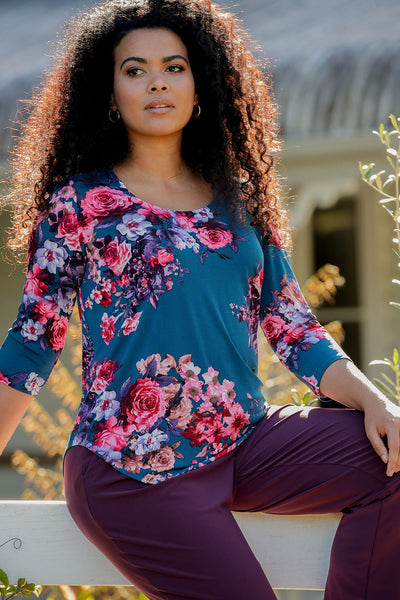 Retro-inspired bouquets of floral placement prints pattern the jersey T-shirt-style body of the round-neck, 3/4 sleeve Jules Top