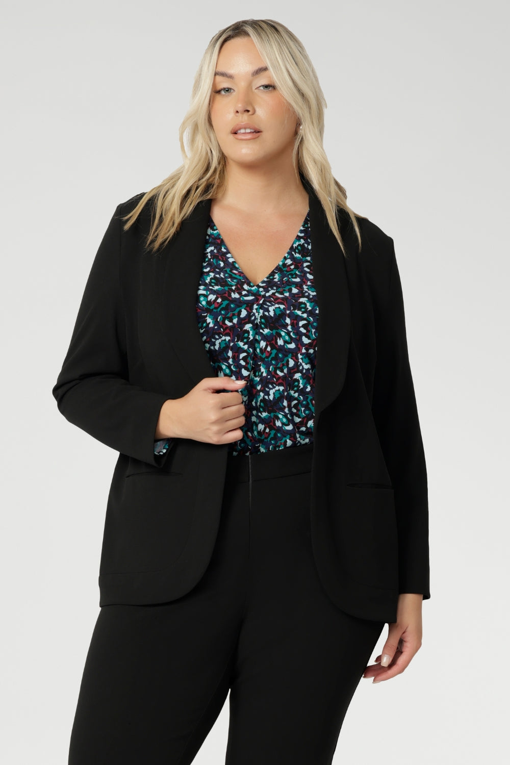 Jersey shirt features a flattering V-neckline with a soft front tuck that adds structure without stiffness, full-length sleeves for added coverage, and a gently curved shirttail hem that creates a clean finish whether worn tucked or loose. A shoulder yoke and centre-back tuck lend subtle tailoring to the relaxed silhouette, making it easy to dress up or down.