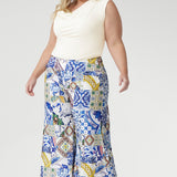 The Dany Culotte in Mosaic Tile brings artful elegance to everyday wear. Made from our soft-touch jersey fabric with gentle stretch and a satin-like feel, this Australian-made culotte showcases a captivating Sicilian-inspired print in cobalt, yellow, brown, and green. Designed with a wide-leg silhouette and cropped length, it offers graceful movement and a flattering shape.
