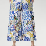 Meet the Dany Culotte in Mosaic Tile — your new go-to wide-leg jersey pant for effortless style and comfort. Crafted from our soft-touch stretch jersey with a silky-smooth feel, this design features a bold mosaic print inspired by Sicilian tilework, blending cobalt, yellow, brown, and green tones over a fresh white base.