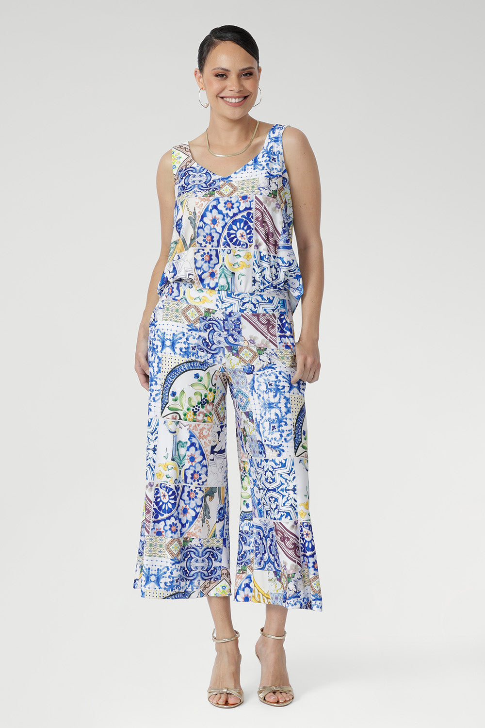 Designed with V-necklines front and back, wide straps for perfect bra coverage, and a shirttail hem, it’s finished with a Sicilian-inspired mosaic print. A versatile piece that brings effortless polish from work to weekend.
