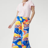 Crafted from our cool-touch slinky jersey, the Dany Culotte in Summer Bliss features a striking abstract print set against a fresh white base. With its wide-leg silhouette and fluid drape, this piece moves beautifully from day to night. Designed for ease with a pull-on waistband and practical side pockets, it delivers both comfort and effortless sophistication — perfect for work, travel, or relaxed weekends.