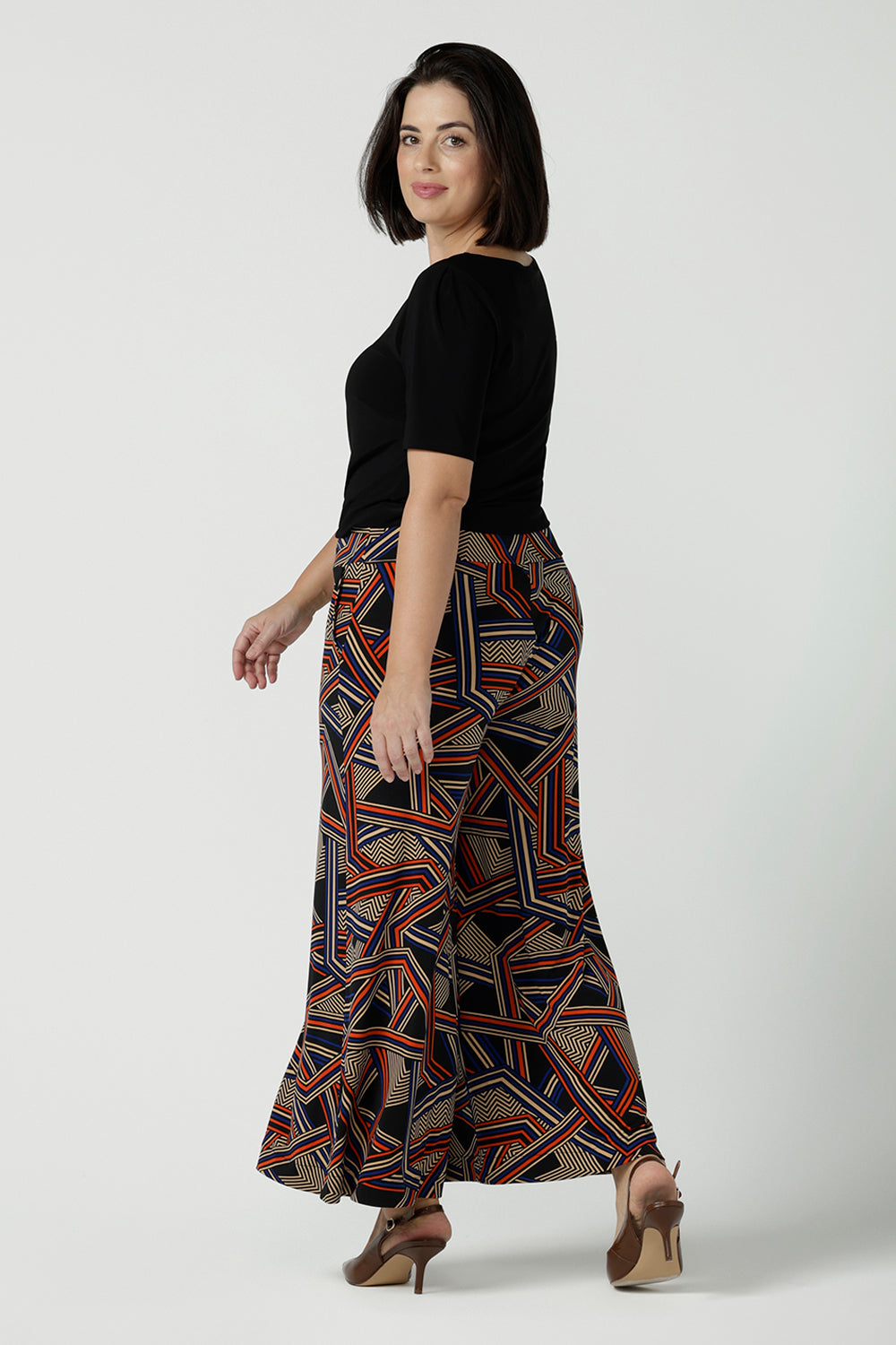 Back view of a size 10 woman wearing the Dany Culotte in Trixie, a printed Jersey work pant with a geometric pattern. Wide leg with functional pockets and wide waistband. Cropped length and petite height friendly. Made in Australia for women size 8 - 24.