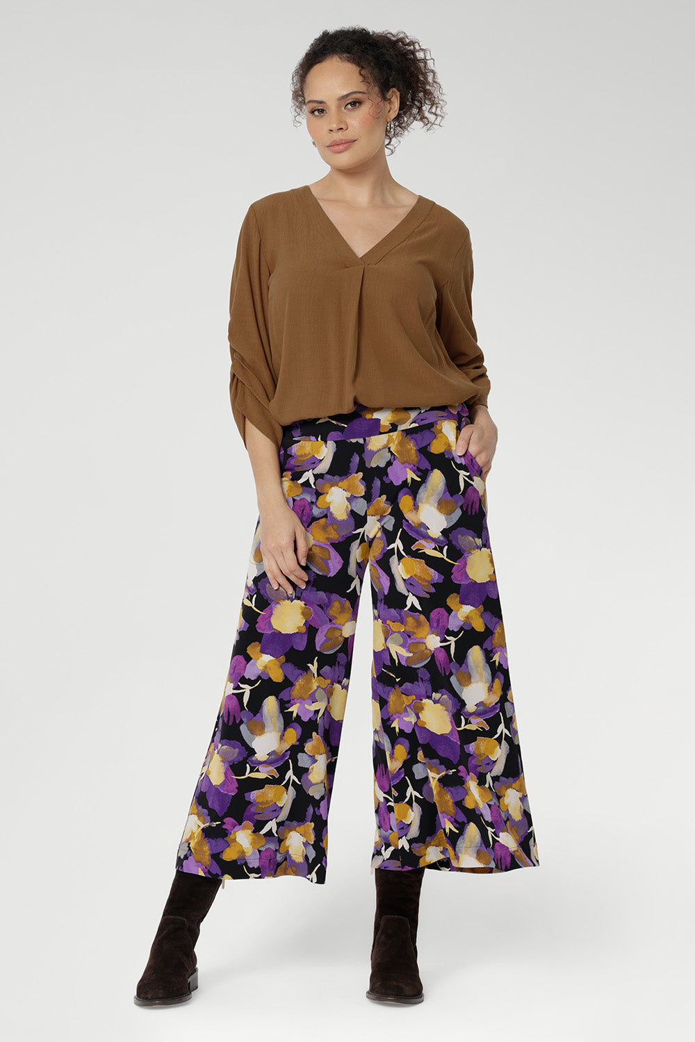 Designed with a double-layer pull-on waistband and functional side pockets with chic visible stitching, the Dany Culotte blends fashion and function seamlessly. Size 10 model wears her culottes with woven blouse tucked in and brown boots.