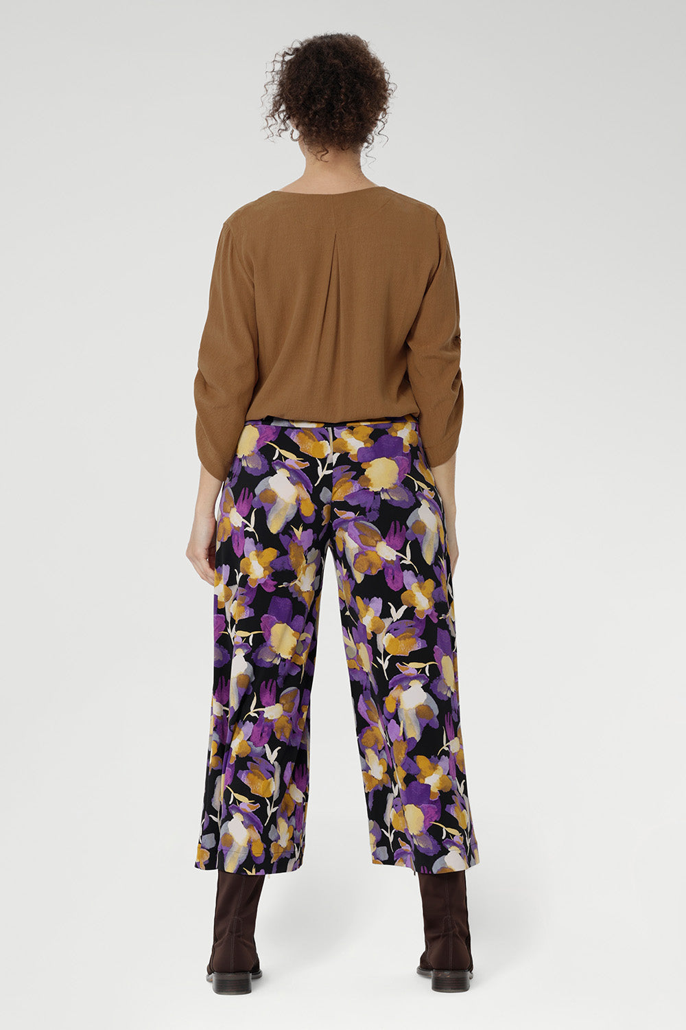Designed with a double-layer pull-on waistband and functional side pockets with chic visible stitching, the Dany Culotte blends fashion and function seamlessly. Size 10 model wears her culottes with woven blouse tucked in and brown boots.