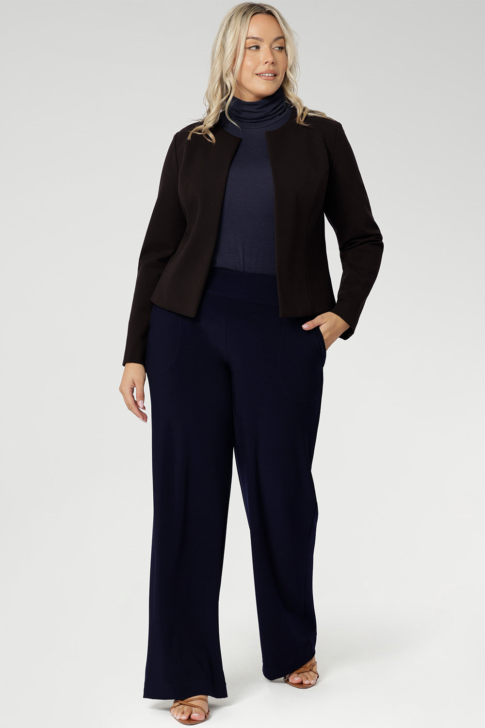 Designed with a sleek, collarless silhouette, the Drake Jacket features a round neckline and an open-front design for easy layering. Double-layered front panels provide a tailored, refined look, while the single-layer back with shaping darts ensures a flattering fit.