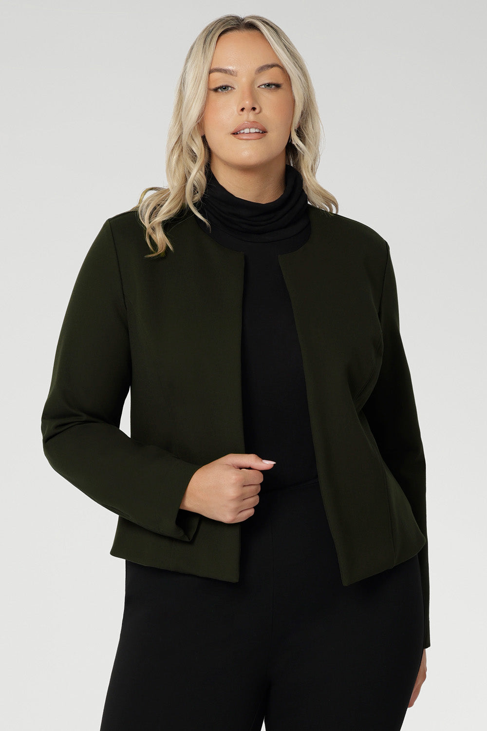 This cropped, collarless jacket features a round neckline and an open-front design, making it a versatile layering essential for the office, weekend outings, or travel.