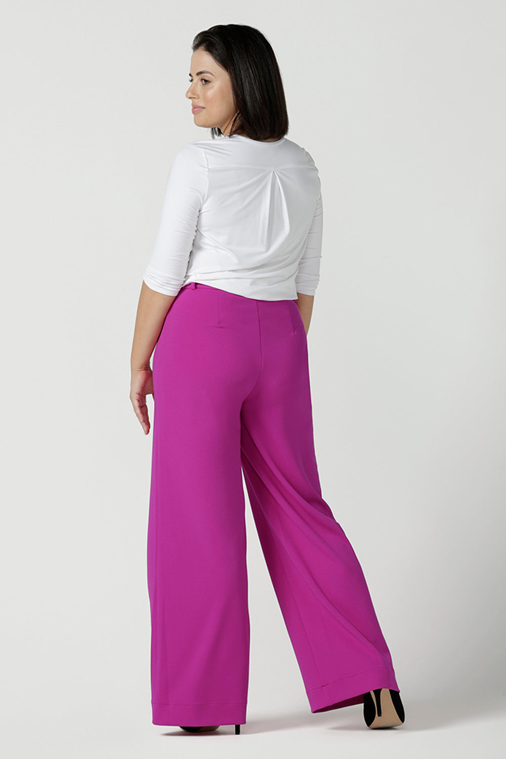 Back view of a size 10 Woman wears the Drew Pant in Fuchsia. A high waist tailored pant with matching suit blazer. Made in Australia for women size 8 - 24.