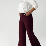The high-rise design offers a flattering and comfortable fit, with a waistband that includes belt loops for added styling options. The invisible front zip with an internal button ensures a sleek, streamlined look while providing a secure fit.