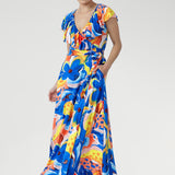 Crafted from our cool-touch slinky jersey, the Elle Maxi Wrap Dress in Summer Bliss combines effortless elegance with modern detail. The wrap silhouette and tie waist create a flattering shape, complemented by a laser-cut raw edge frill for a touch of lightness. With pockets and a double-layered back for comfort, this abstract floral dress is made for summer festivals, garden parties, and relaxed occasions.