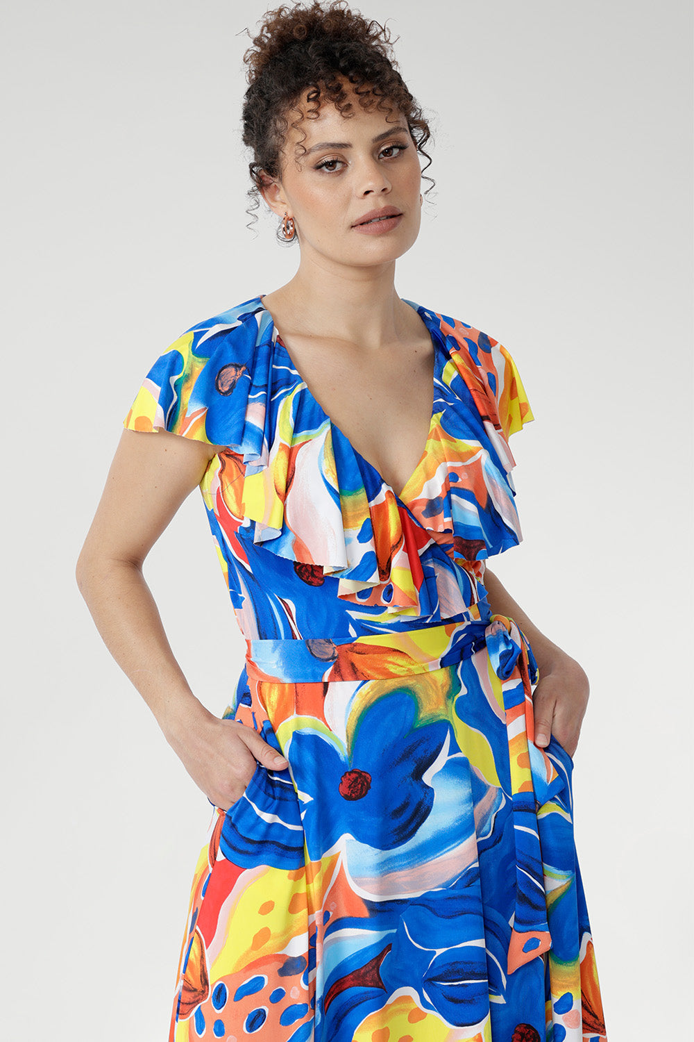 The Elle Maxi Wrap Dress in Summer Bliss reimagines summer dressing with fluid lines and modern femininity. Crafted from cool-touch slinky jersey, it features a flattering wrap design with a tie waist and a laser-cut raw edge frill that lends a light, contemporary edge.