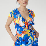 The Elle Maxi Wrap Dress in Summer Bliss reimagines summer dressing with fluid lines and modern femininity. Crafted from cool-touch slinky jersey, it features a flattering wrap design with a tie waist and a laser-cut raw edge frill that lends a light, contemporary edge.