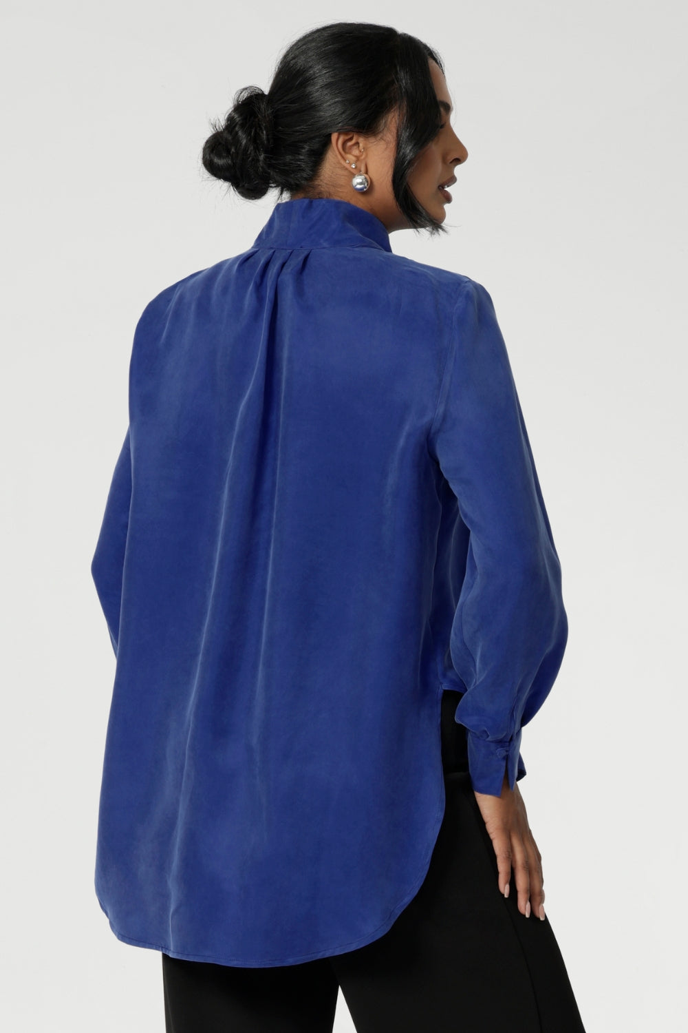 Suede touch Tencel shirt features a collared V-neckline, cuffed sleeves and shirttail hemline that sits longer at the back. Womans workwear blouse has a luxurious feel and drape. Proudly made in Australia in sizes 8-24.