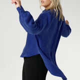 Plus size woman wears oversized blouse made from suede touch Tencel fabric. Workwear shirt features a collared V-neckline, cuffed sleeves and shirttail hemline that sits longer at the back. Woman's workwear clothing proudly made in Australia in sizes 8-24.