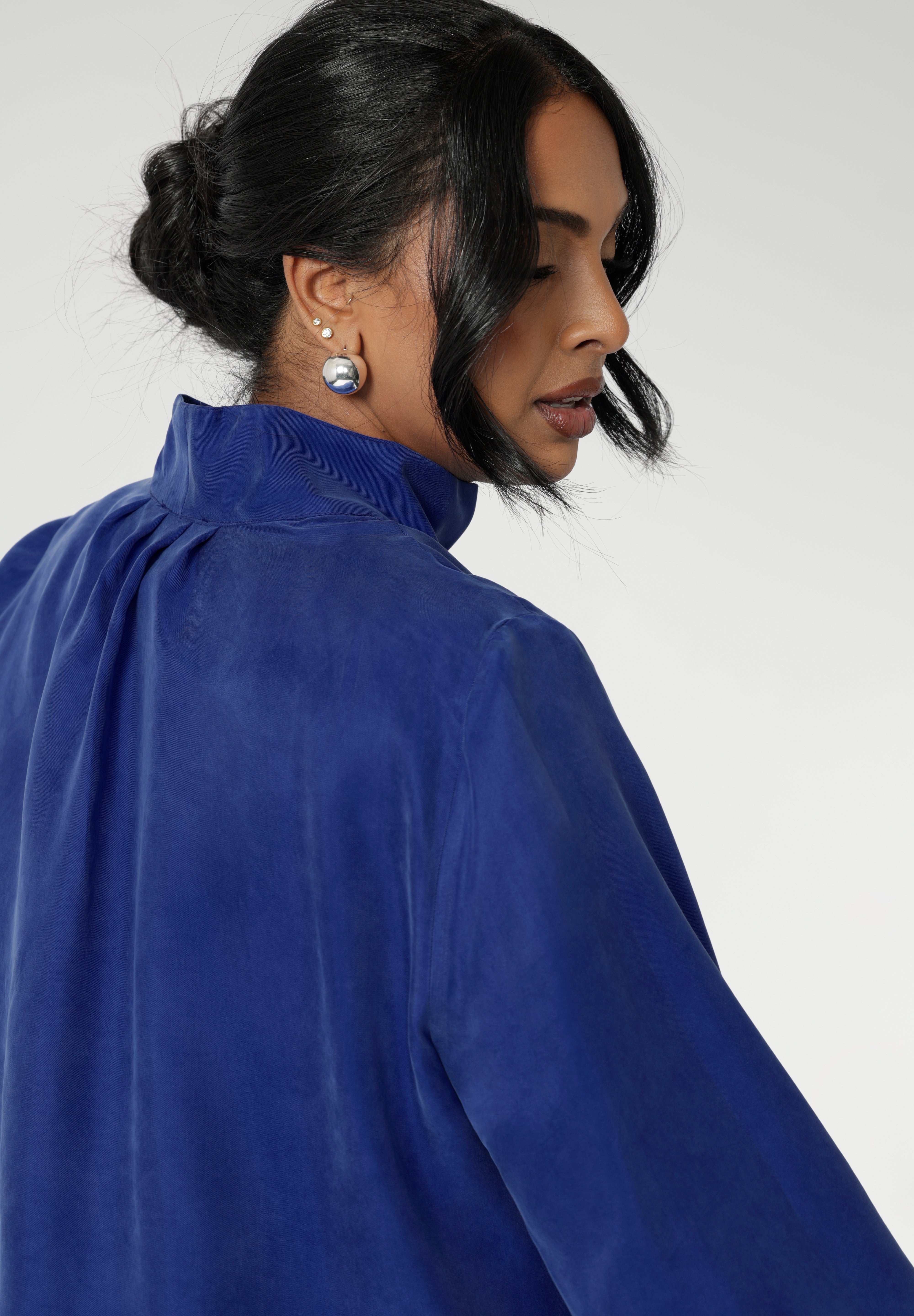Workwear shirt features a collared V-neckline, cuffed sleeves and shirttail hemline that sits longer at the back. Woman's workwear clothing proudly made in Australia in sizes 8-24.