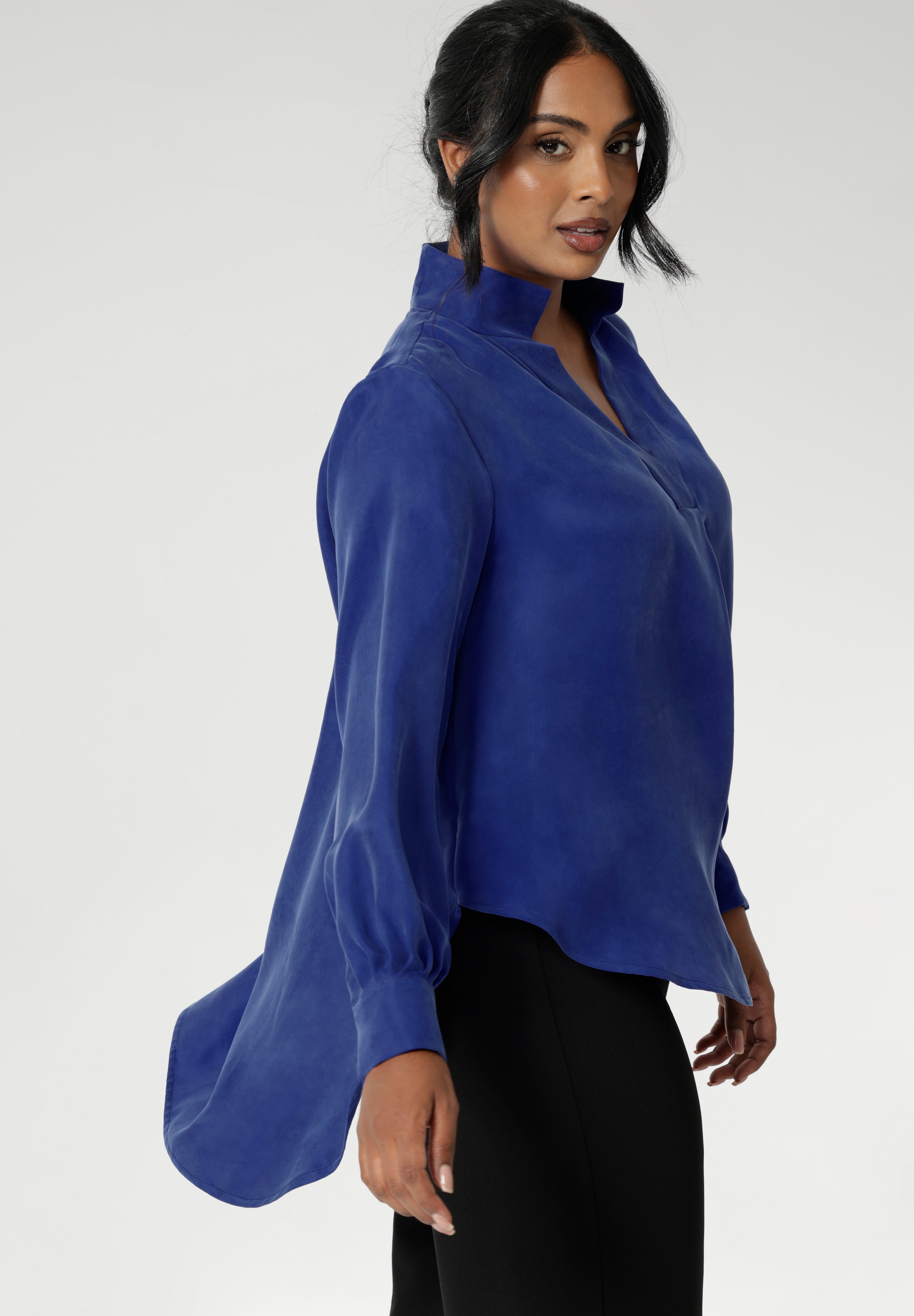 The Ellis Shirt in Cobalt has an oversized fit, designed to be worn loose or front-tucked. Ellis is a pull-on style shirt featuring a collared V-neckline, cuffed sleeves and shirttail hemline that sits longer at the back. Crafted from suede touch Tencel fabric that has a luxurious feel and drape. Proudly made in Australia in sizes 8-24.