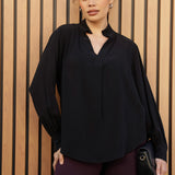 A size 10 woman wears the Ellis shirt made from Australian made graphite tencel fabric. With cuff detail and collared neckline. Made in Australia for women size 8-24.