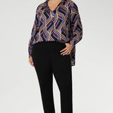 A structured collar frames the neckline, leading into a soft V-neckline with a tailored tuck at the centre, adding subtle shaping to the relaxed design. Thoughtful tuck details at the back enhance the swing silhouette, offering both style and structure.