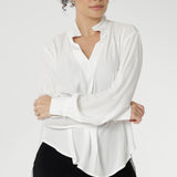 A size 10 woman wears the Ellis shirt in Vanilla tencel, a high quality made in Australia womens shirt made in breathable tencel. Inclusive size range 8-24 and made in Australia. Styled back with Black Tube Skirt