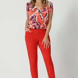 The pants are designed with angled front pockets, giving them a modern touch, while the back darts ensure a tailored fit that contours to the shape of the body. The tapered legs provide a sleek silhouette, and the ankle-length design adds a trendy, contemporary edge.